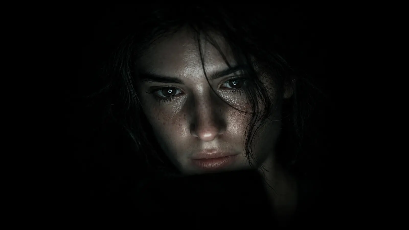 A face lit by the glow of a phone in the dark